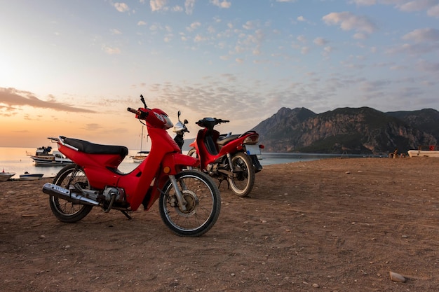 Morning on the beach in the village of Cirali red scooters stand on the beach morning scooters ride Landscapes of the Lycian Trail