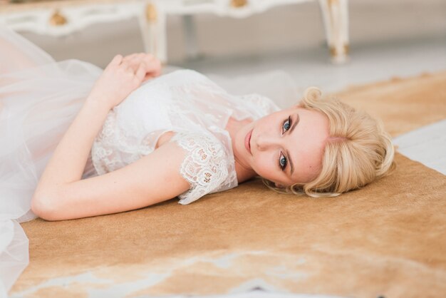 Morning of a beautiful young bride in a boudoir dress