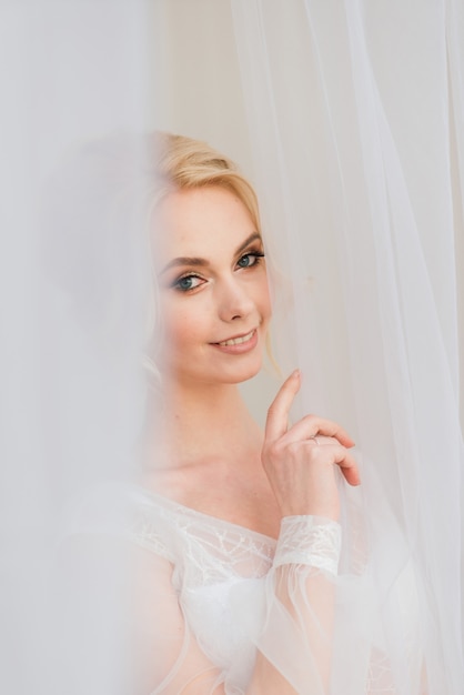 Morning of a beautiful young bride in a boudoir dress