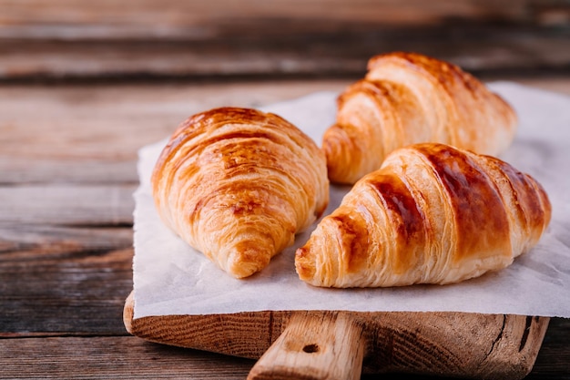Morning breakfast Homemade baked croissants on wooden rustic background