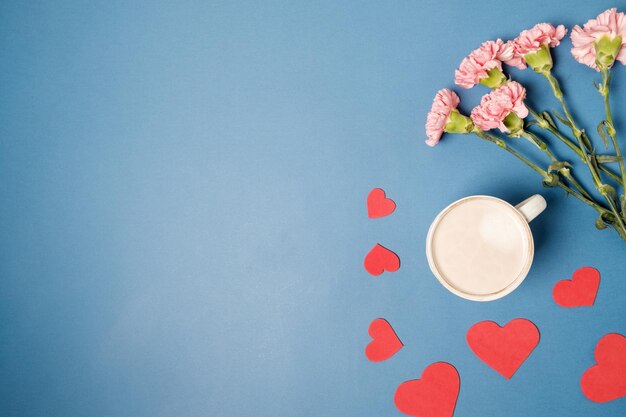 Morning breakfast for Valentines day Coffee chocolate candies gift boxes paper heart on yellow background Top view Flat lay