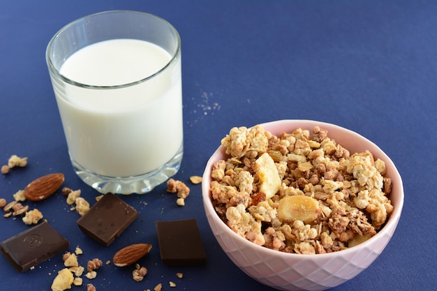 morning breakfast with bowl of banana granola and glass of milk, close-up