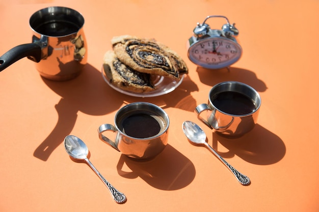 Morning breakfast with coffee on an orange background on a sunny morning