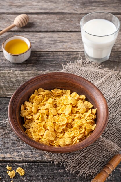 Morning breakfast with cornflakes, milk and honey