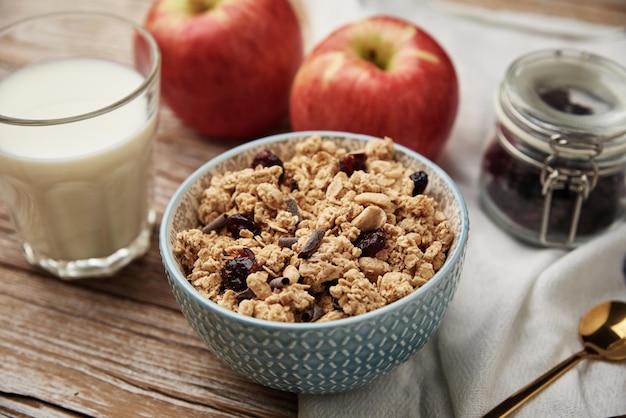 Morning breakfast with granola on wooden background