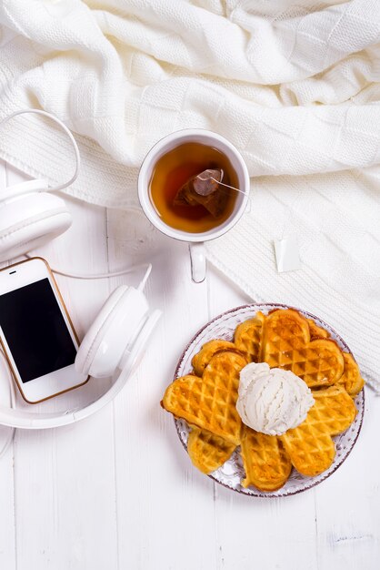 Morning breakfast with waffles and tea in bed