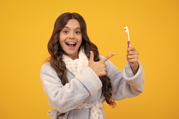 Morning brushing teeth dental care hygiene and child teenage girl with toothbrush brushing teeth shocked surprised teenager girl