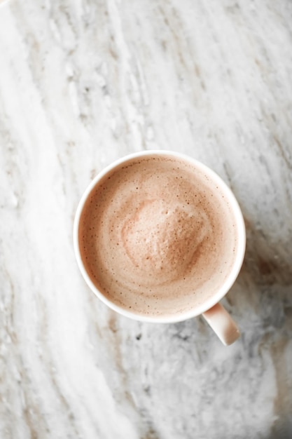 Morning coffee cup with milk on marble stone flat lay hot drink\
on table flatlay top view food photography and recipe inspiration\
for cooking blog or cookbook