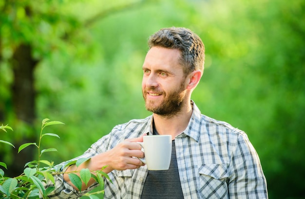 Morning coffee healthy lifestyle nature and health drink tea outdoor ecological life for man man in green forest breakfast refreshment time happy man with cup of tea Good morning coffee