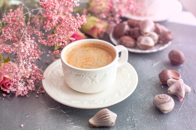 morning coffee in a white cup with seashells. 