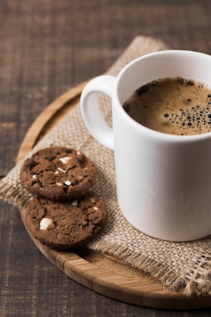 Morning coffee in white mug and cookies