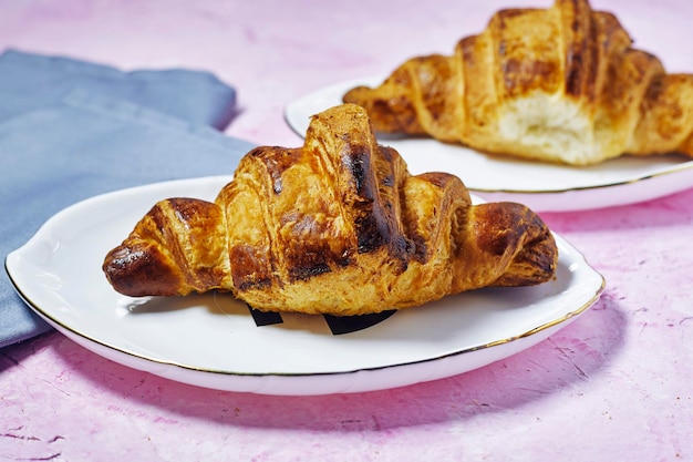 morning concept Fresh baked croissants in white plate for breakfast