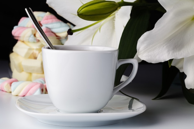 Morning cup of tea, white lily, colored marshmallow