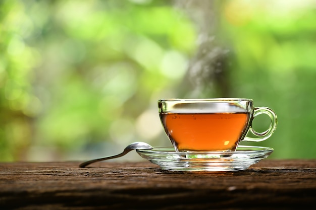 Photo morning cup of tea with smoke on nature background