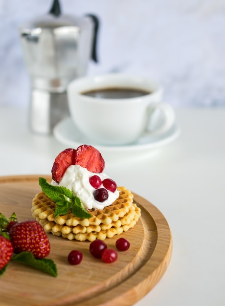 Morning delicious breakfast with coffee and crispy belgian waffles 