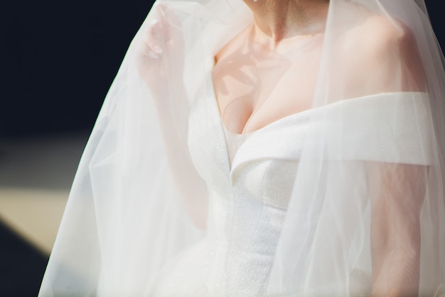 Morning gathering of the bride. Suspension on the neck. Beautiful neckline. Close-up.