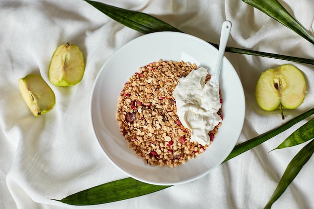 Morning granola breakfast with greek yougurt and apple