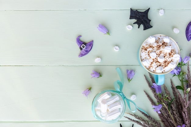 Morning holiday coffee for Halloween with marshmallows. top view copy space