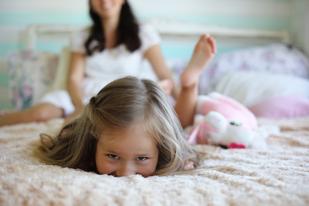 Morning idleness. Mom and daughter have fun.