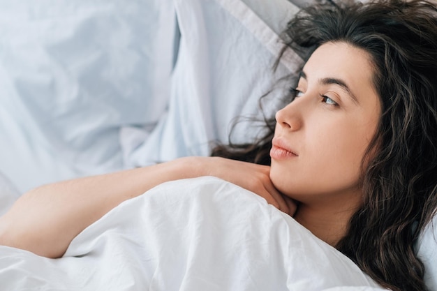 Morning melancholy pensive sad woman in bed alone