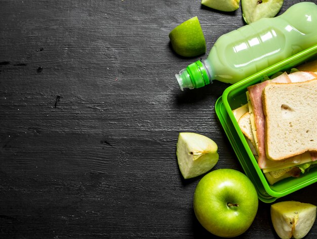 Morning picnic. Sandwiches a milkshake and fruit.