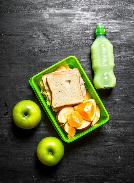 Morning picnic. Sandwiches a milkshake and fruit.