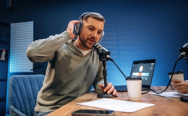 Morning radio Man with microphone in the studio conception of podcast