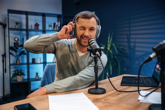 Morning radio Man with microphone in the studio conception of podcast
