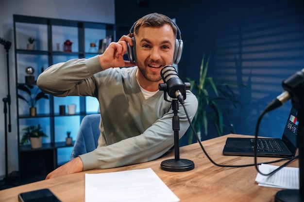 Morning radio Man with microphone in the studio conception of podcast