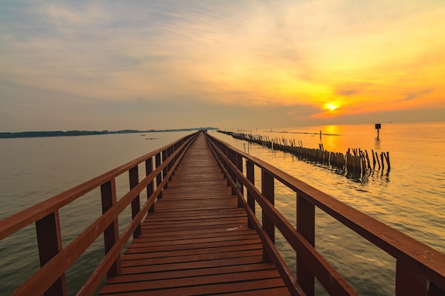 In the morning The red bridge and sun up on horizon. bridge cross sea in Thailand.