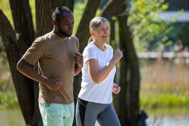 Morning run Man and woman having a morning run together in the park