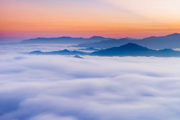 Photo morning scenery the sun rises there is a sea mist in the morning with a beautiful mountain range, southern scenery of thailand.