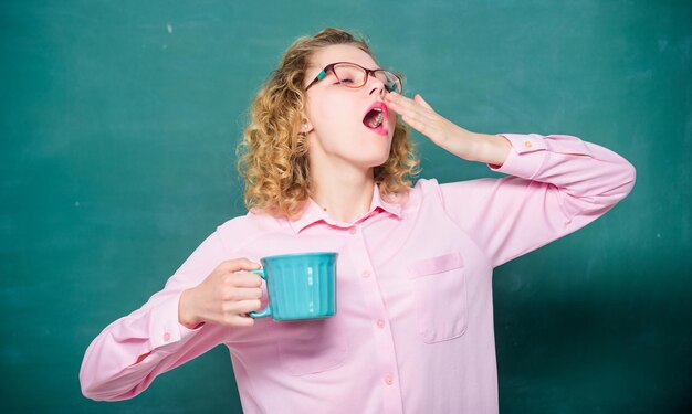 Morning starts with coffee energy and vigor energy charge idea and inspiration yawning girl with coffee cup at blackboard school teacher need coffee good morning girl refreshing with tea drink