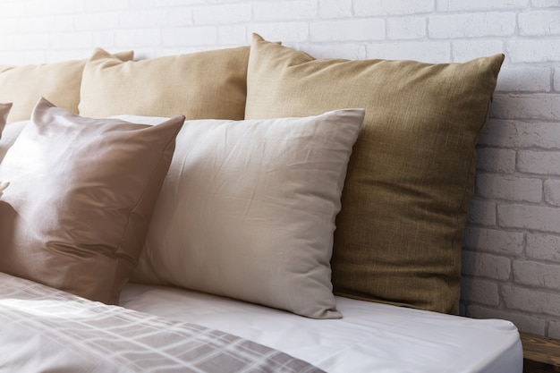 Morning sun light on clean white pillows and bed sheets in bedroom