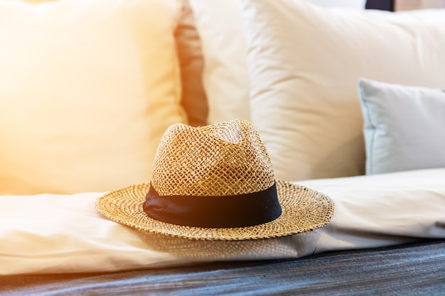 Morning sun rise on a hat and pillows and bed sheets in hotel's bedroom.