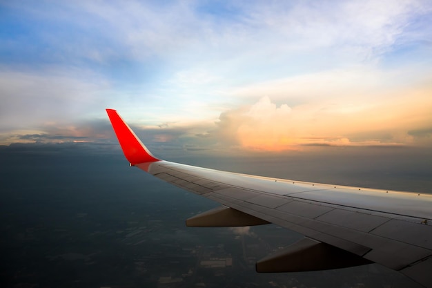 Morning sunrise with wing of an airplane flying above the ocean\
the view from an airplane window photo applied to tourism operators\
picture for add text message or frame website