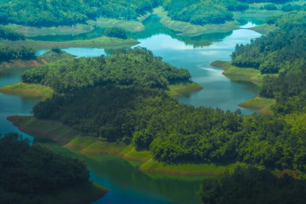 Morning at the ta dung lake or dong nai 3 lake with green hills\
and mountains travel and landscape concept travel concept