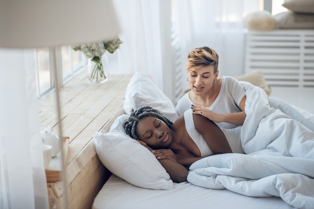 Photo morning. two girls in a bed in their bedroom in the morning