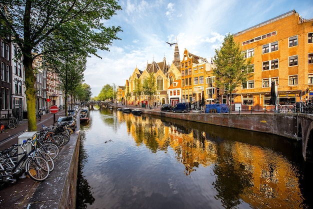 Morning view on the beautiful buildings and water channel in Amsterdam