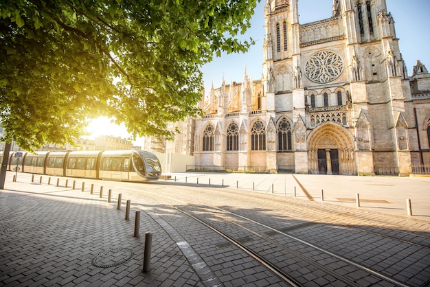 Morning view on the beautiful saint Pierre cathedral with modern tram in Bordeaux city, France