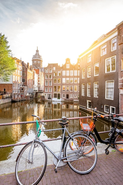 Morning view on the water channel with Saint Nicholas church in Amsterdam