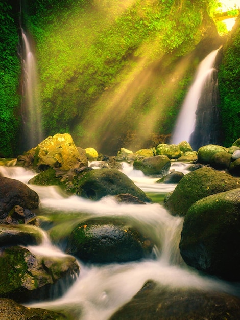 Morning view at waterfall with shining sun