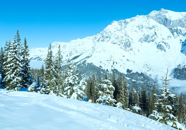 Morning winter mountain landscape with clouds in below valley (Hochkoenig region, Austria)