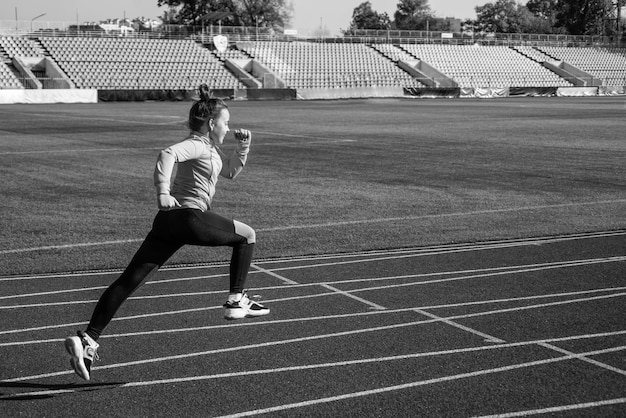 Morning workout sprinter warming up on stadium gym flexibility child training at school physical education lesson speed and motion stamina teenage girl run marathon runner on race competition