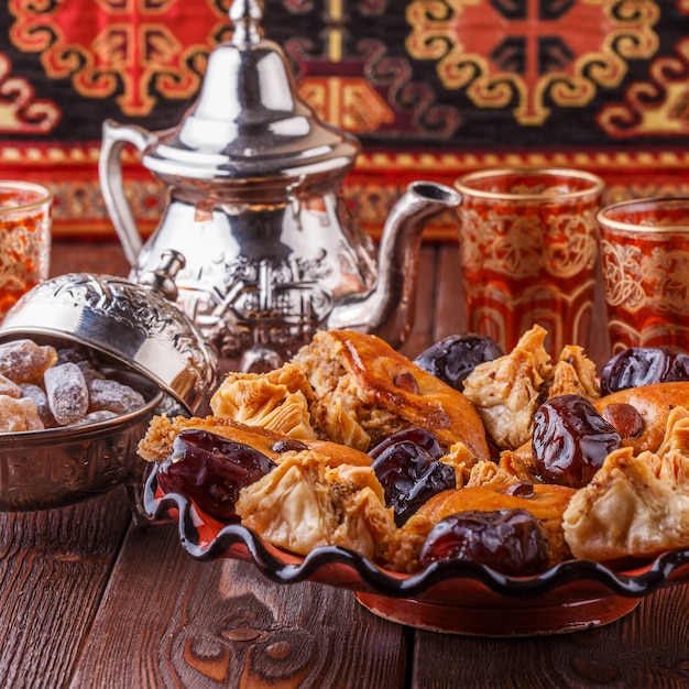 Moroccan mint tea in the traditional glasses with sweets