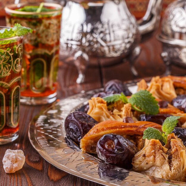 Moroccan mint tea in the traditional glasses with sweets