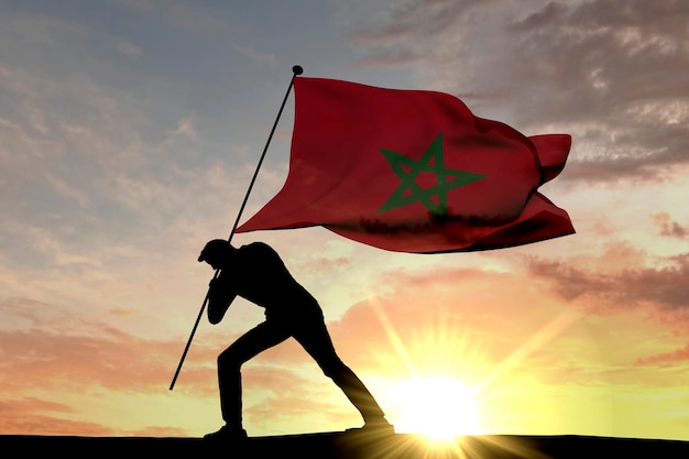 Фото Флаг марокко вдавлен в землю мужским силуэтом 3d rendering