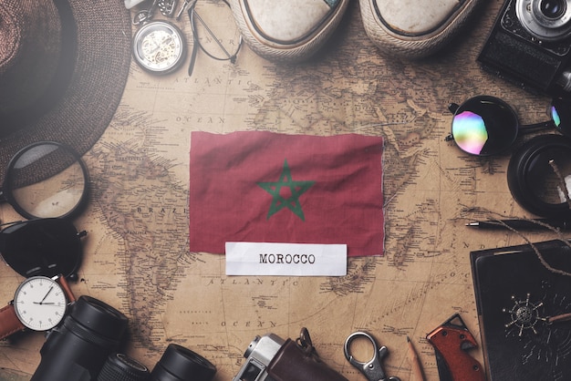 Morocco Flag Between Traveler's Accessories on Old Vintage Map. Overhead Shot