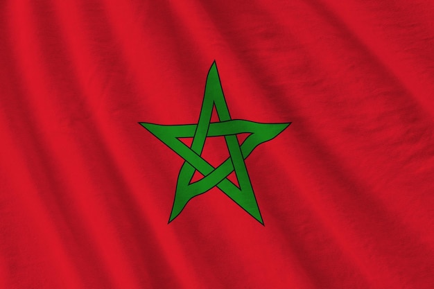 Morocco flag with big folds waving close up under the studio light indoors The official symbols and colors in banner