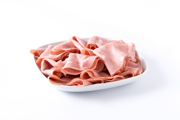 Mortadella slices on white plate isolated